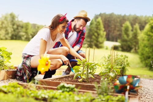 Gardeners working safely in a residential garden in Crossness