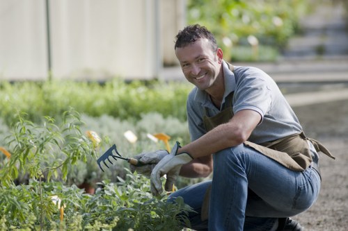 Professional gardeners using safe working practices on site